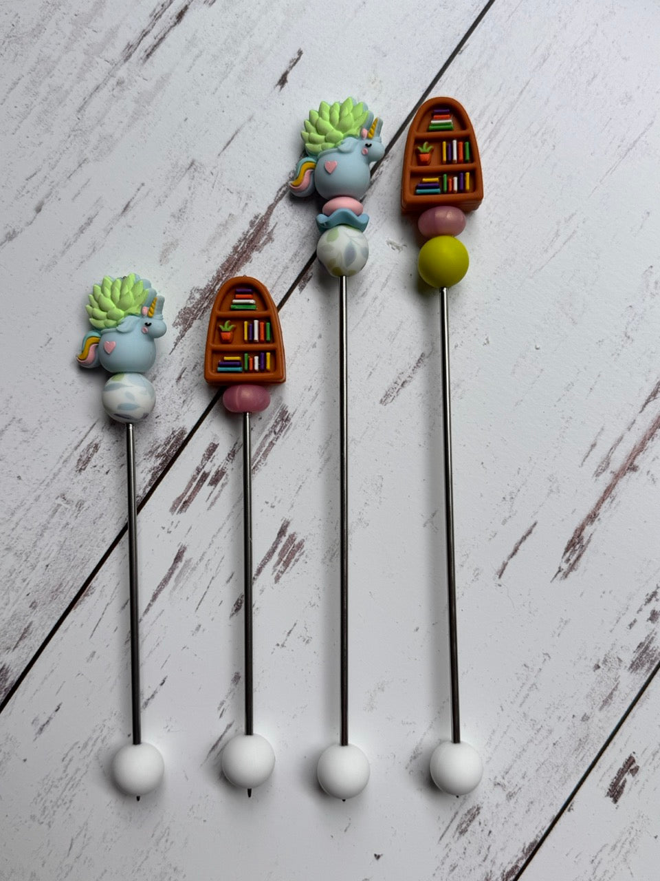 Bookcase with Unicorn Succulent Pair of Amigurumi Sewing Sticks