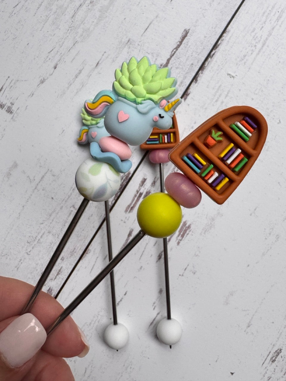Bookcase with Unicorn Succulent Pair of Amigurumi Sewing Sticks